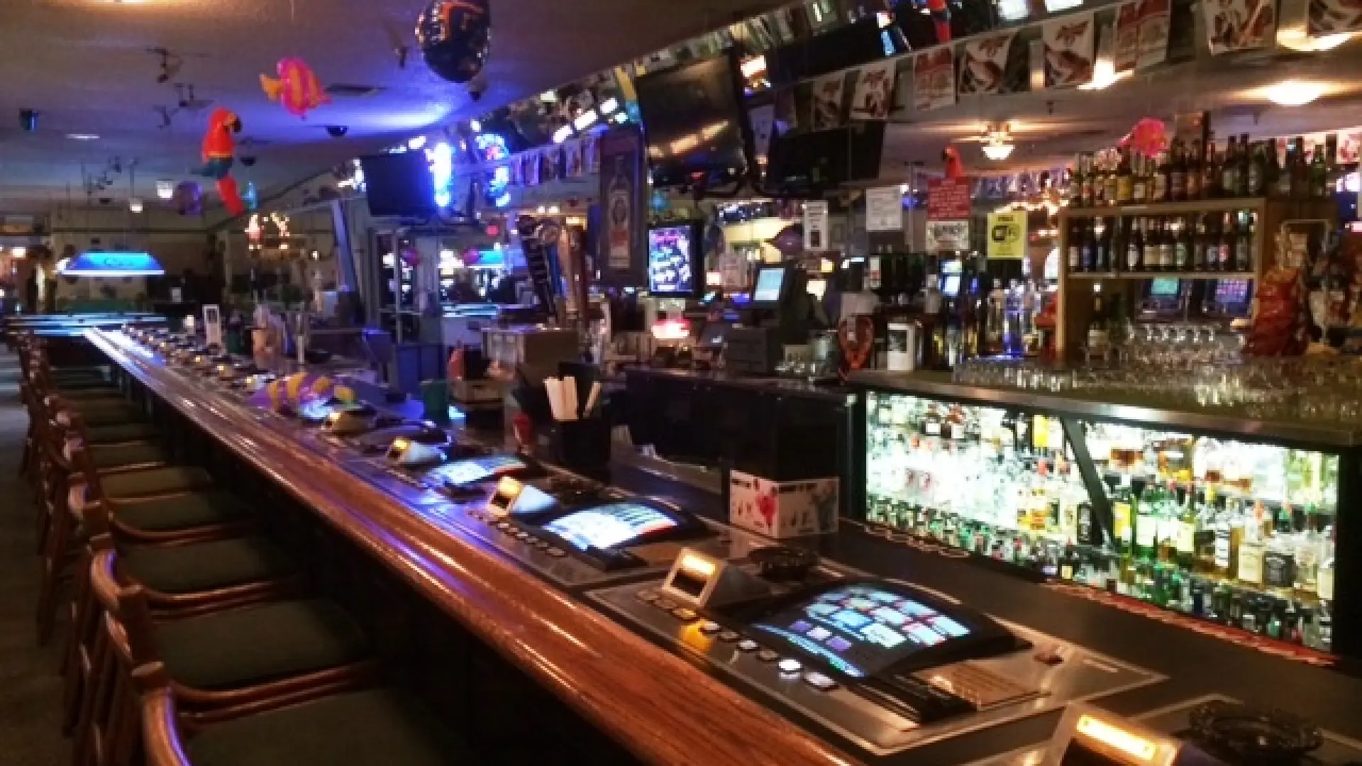 Empty, fully-stocked bar with gambling machines